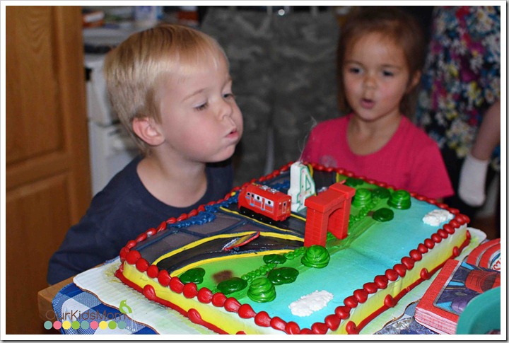 boy blowing out candles